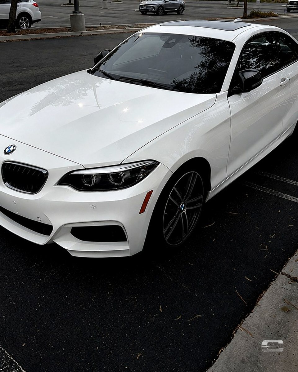 White BMW coupe after detailing, paint finished glossy